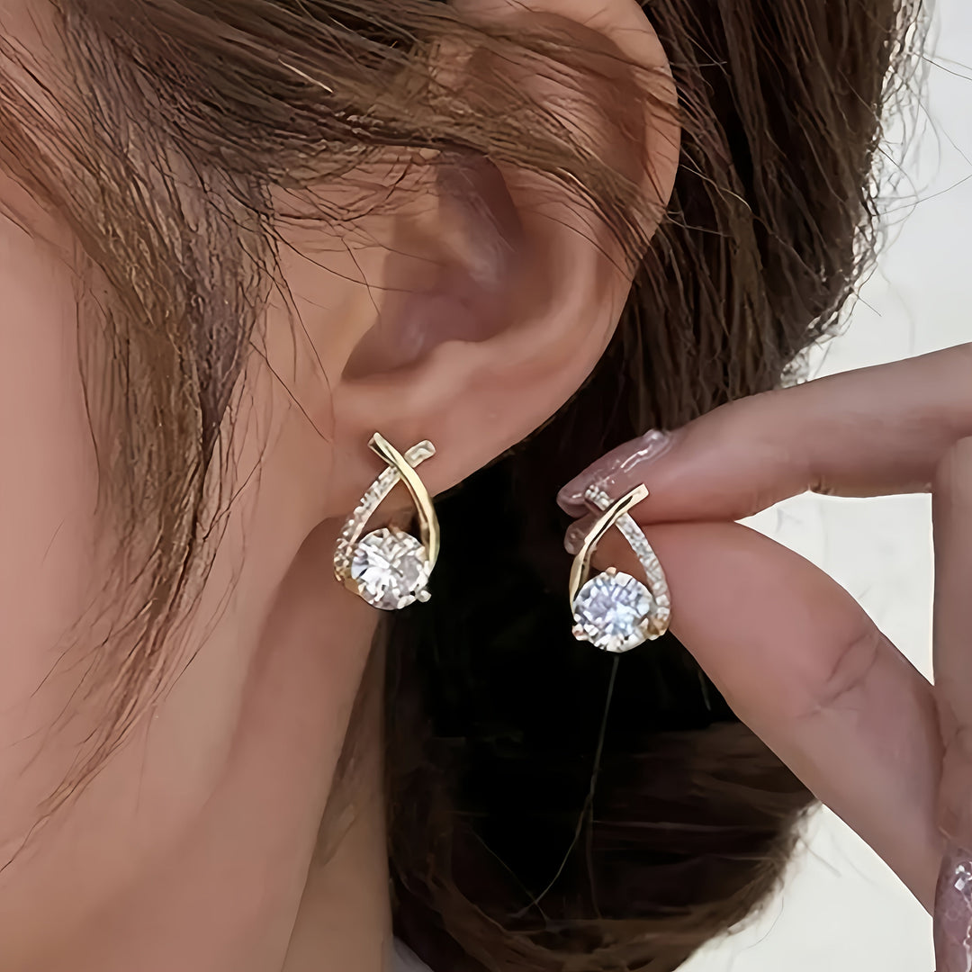 Stud earrings with golden cross and zirconia