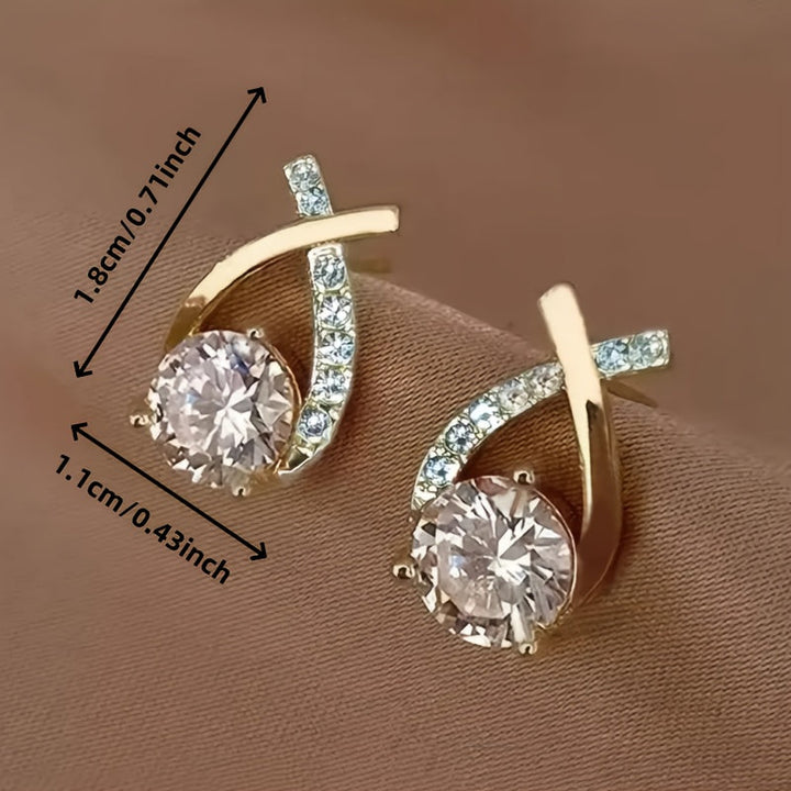 Stud earrings with golden cross and zirconia