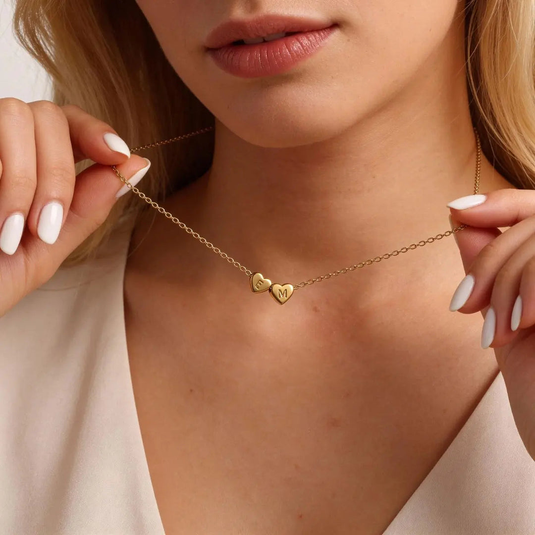Heart initial necklace styled on a neck