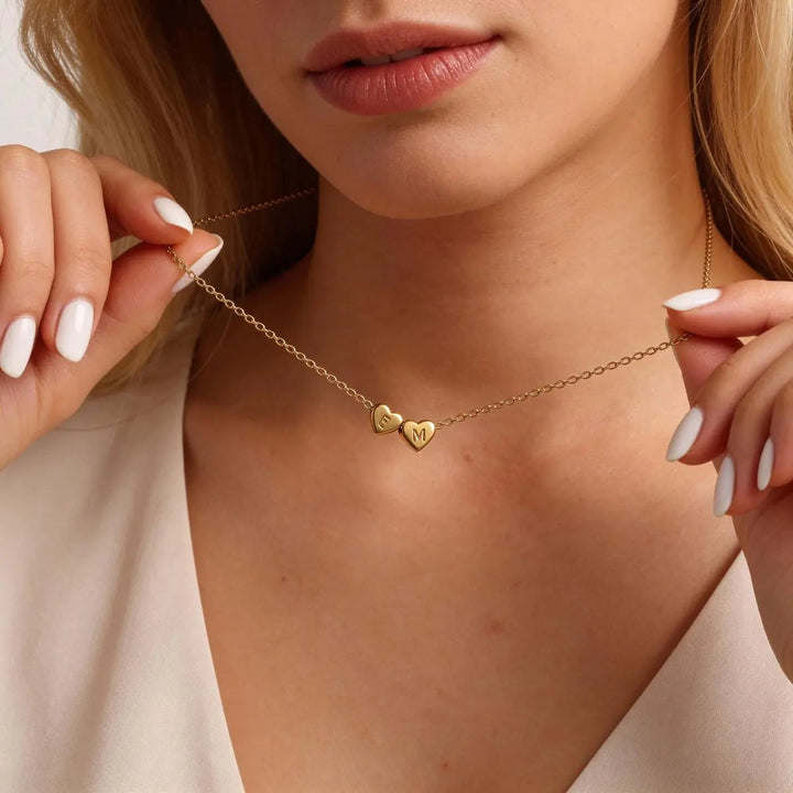 Heart initial necklace styled on a neck