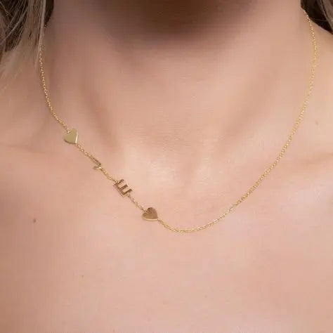 Sideways letter pendant photographed with flowers