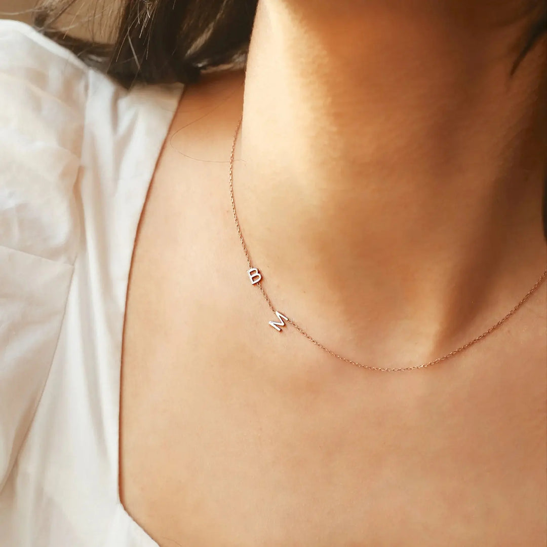 Sideways initial necklace detail