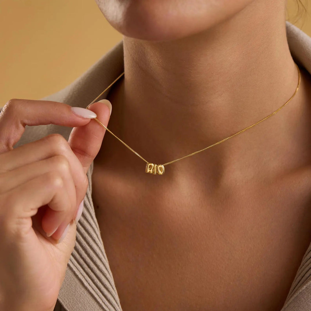 Tiny balloon letter name necklace detail