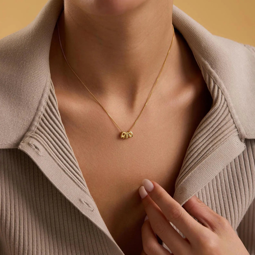 Tiny balloon letter name necklace worn