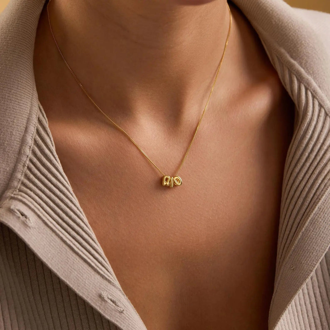 Tiny balloon letter name necklace close-up