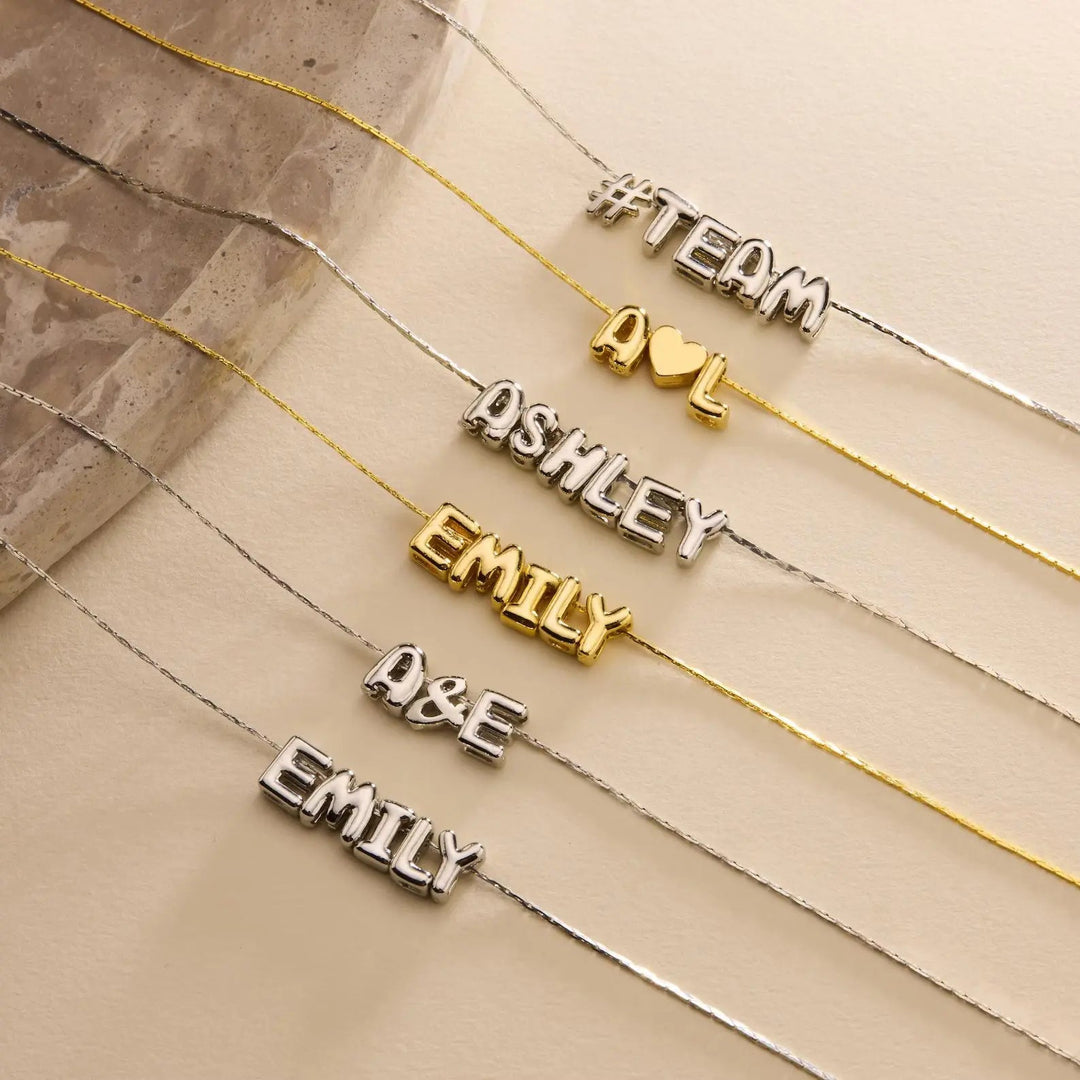 Tiny balloon letter name necklace in silver