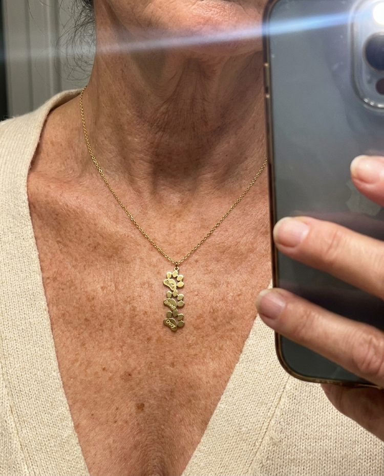 Customer wearing the Custom Paw Name Necklace in gold