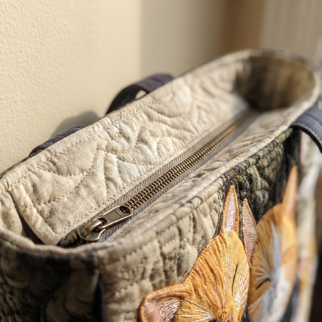Close-up of quilted stitching and zipper