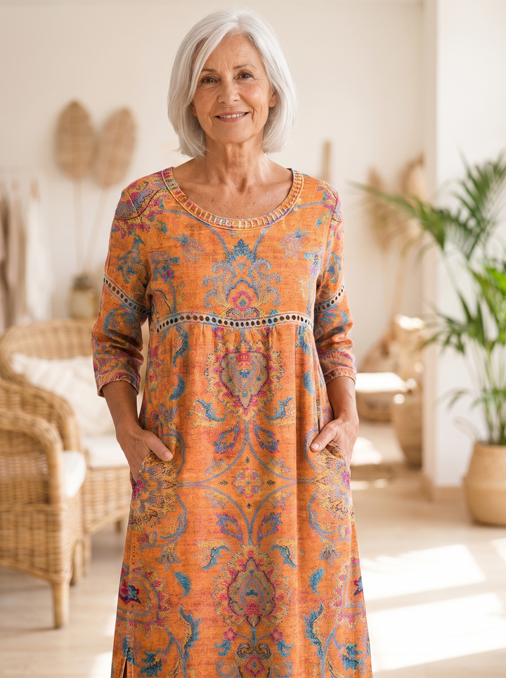 Older woman wearing the Eugenia printed dress, hands in the side pockets