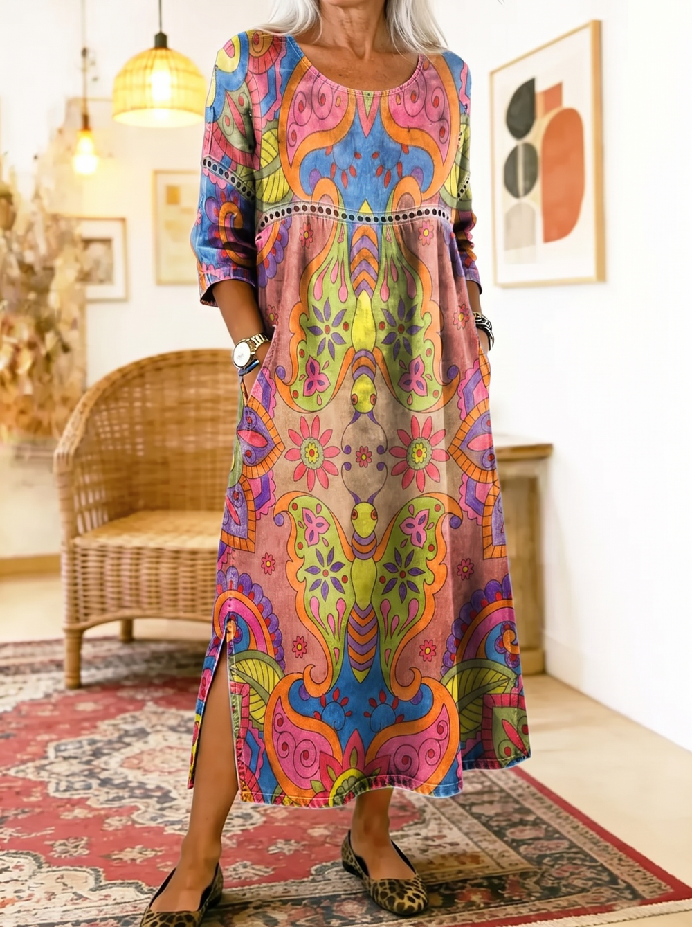 Older woman wearing the Incarnation printed dress, hands in the side pockets