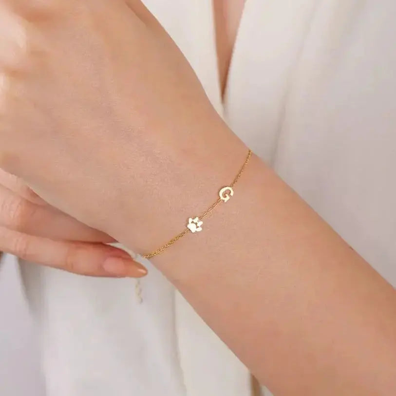 Sideways initial bracelet in gold lifestyle shot