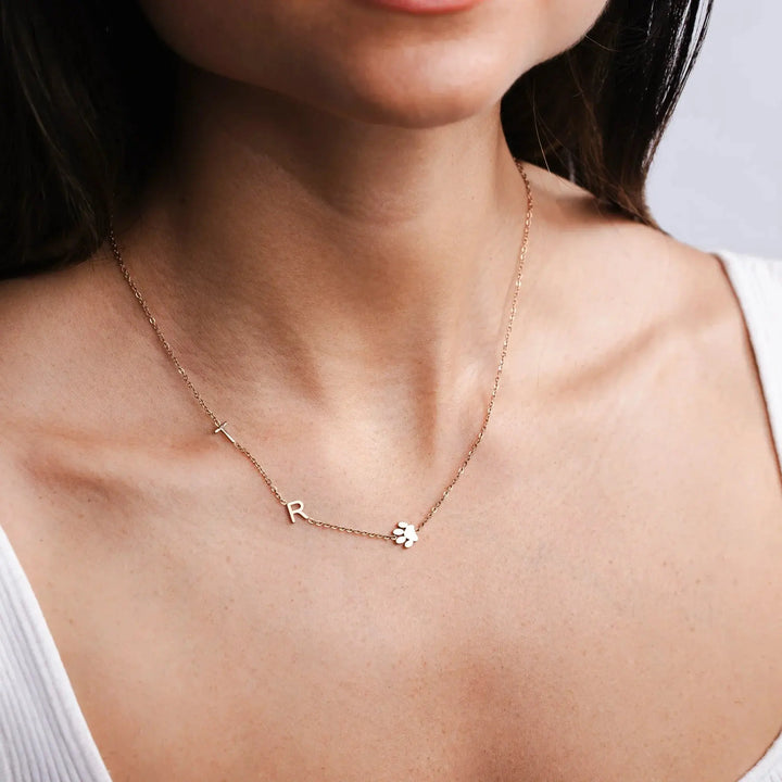 Multiple sideways initial necklaces layered